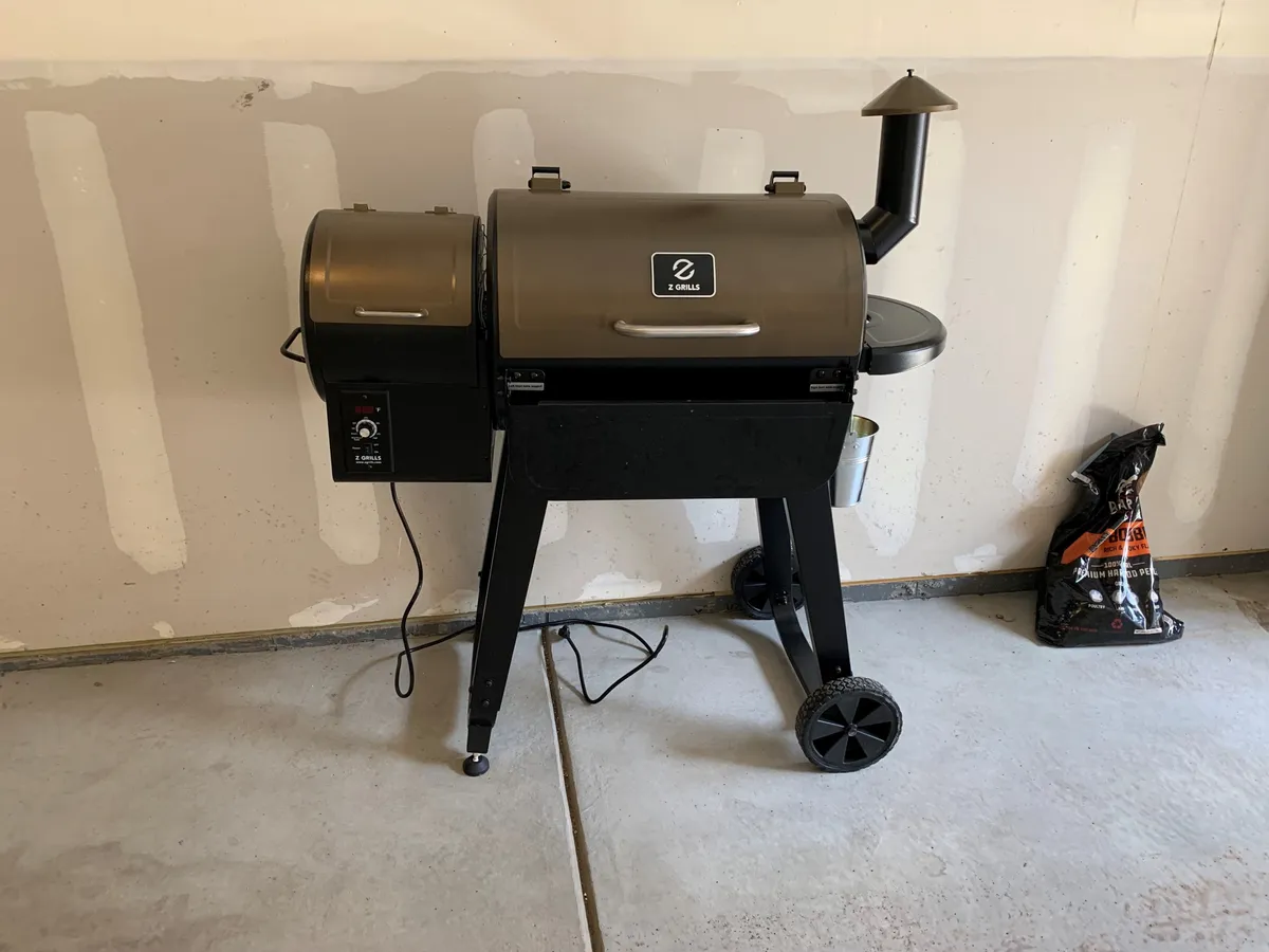 A sleek, modern grill setup with a charcoal bag nearby, highlighting a dedicated space for barbecuing and outdoor cooking. The scene is casual yet inviting, perfect for gathering after a day of adventure.